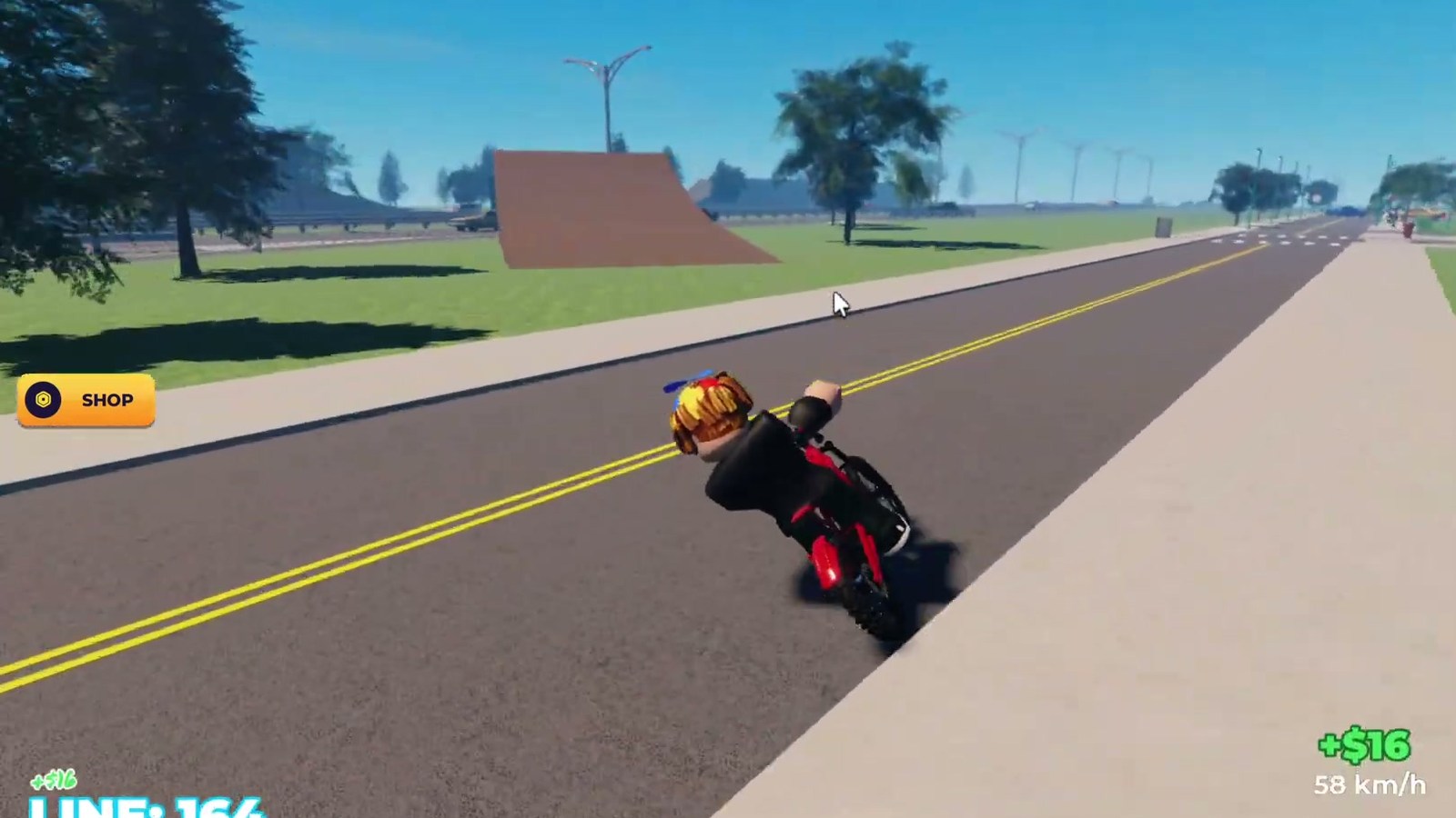 A rider on a marked road in Bike Universe, with ramps and wind turbines along the highway