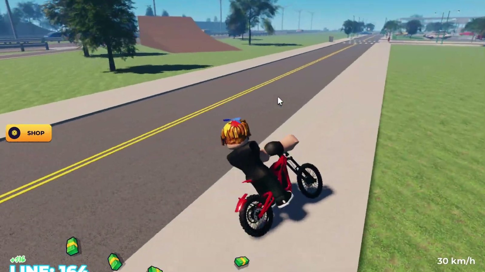 A rider on a red bike on a marked road in Bike Universe, with the speed and cash readouts on screen